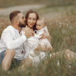 Happy family enjoying quality time in a serene meadow setting.